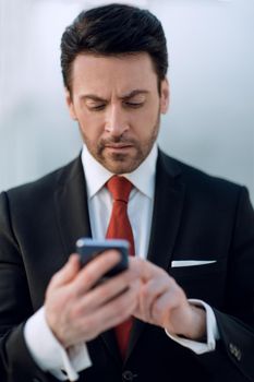 close up.businessman holding a smartphone.people and technology