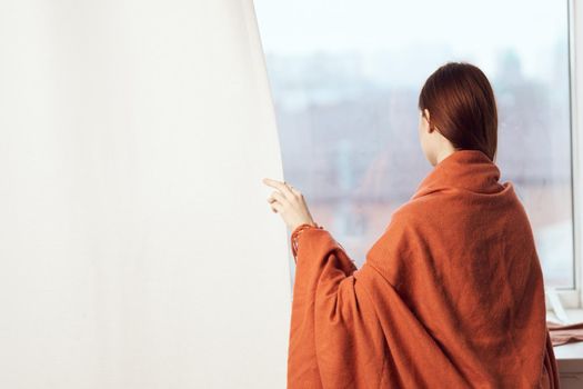 woman with a cup of drink on the windowsill reading a book rest morning. High quality photo