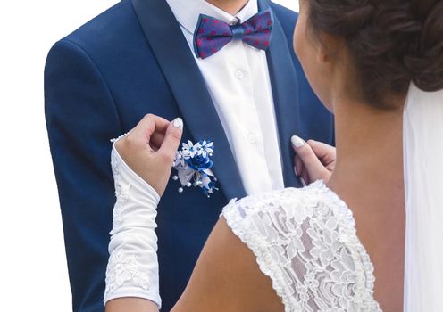 The bride and groom's hug at the wedding. A man in a blue suit and white shirt, with a butterfly hugs a girl in a white dress.