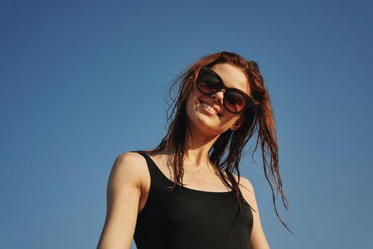 woman in black swimsuit sunglasses sun nature. High quality photo