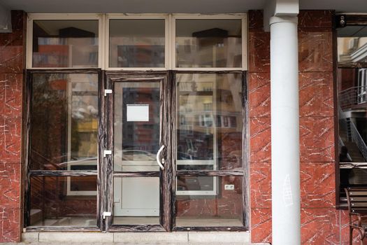 Outside solid glass door with building exterior.