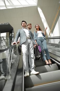 business colleagues going down the escalator in the business center.business concept