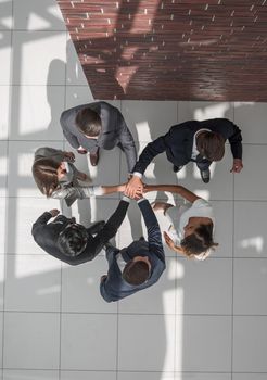 top view. a group of business people with their hands folded together. the concept of unity