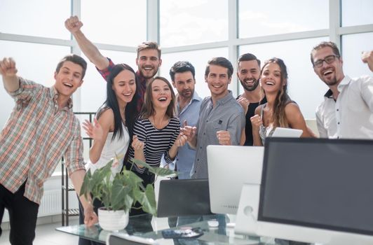 happy business team standing in new office.the concept of a startup