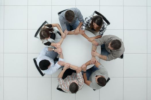 top view.The business team hold hands, forming a circle.the concept of unity