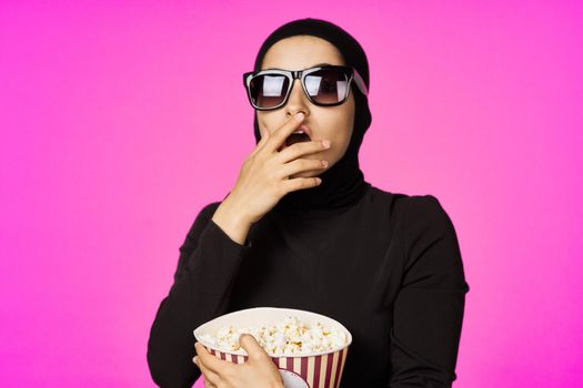 Muslim woman attractive look popcorn glasses movie watching isolated background. High quality photo