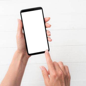 User holding modern smartphone with white screen in hand