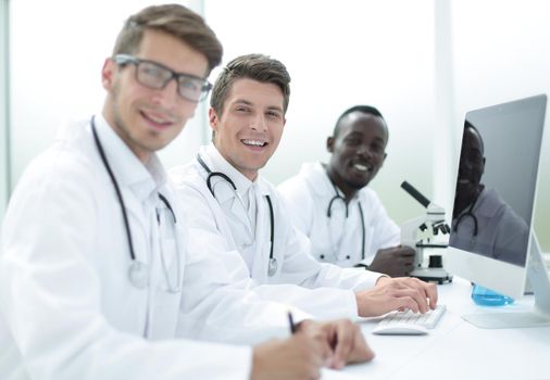 team of doctors sitting at the laboratory table .the concept of health