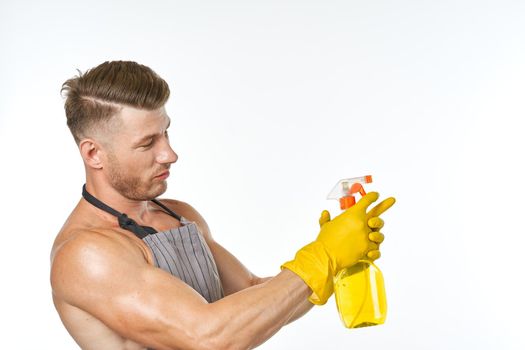 emotional man in apron with detergent cleaning housework. High quality photo