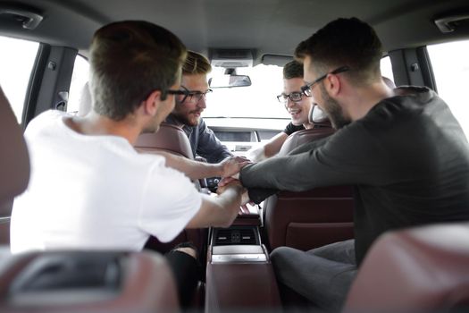 Conversation of four business colleagues in a moving car