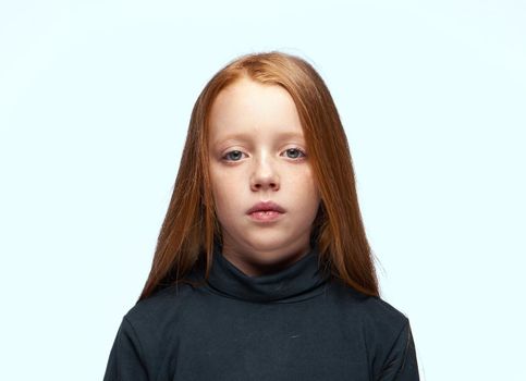 red-haired girl in a black sweater planning close-up. High quality photo