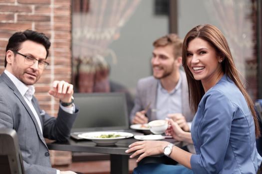 close up.business team sitting at a table in a cafe.the concept of teamwork