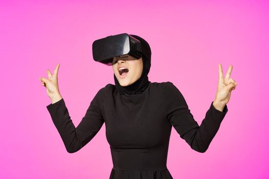 woman in black hijab glasses virtual reality technology movie watching. High quality photo