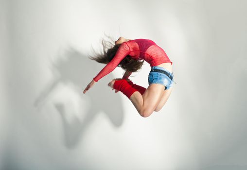 Modern style dancer posing on a studio white background