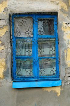 old window on facade of the old house