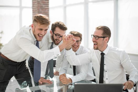 employees giving each other a high five.success concept