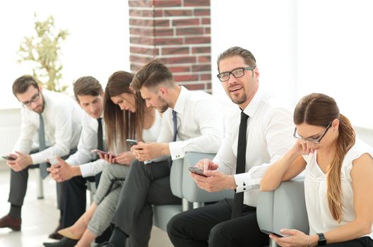 group of employees is waiting for the start of a business meeting .business concept