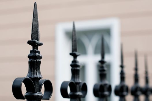 old beautiful metal fence with building in background