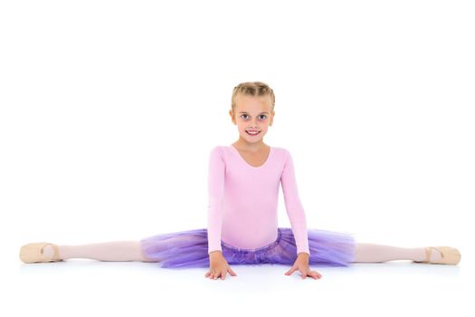 A little girl performs a gymnastic twine. The concept of fitness and sports. Isolated on white background.