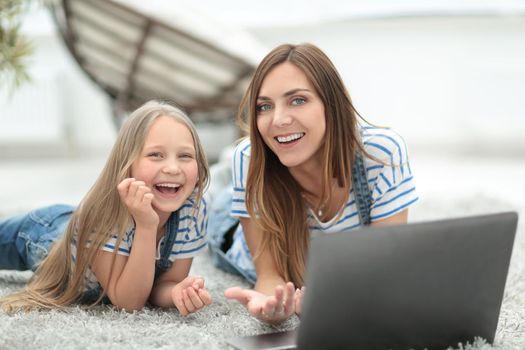 smiling mother and daughter spend their free time together.people and technology