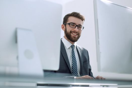 businessman working on a computer sitting at his Desk.people and technology