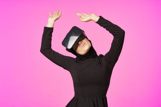 woman in black hijab glasses virtual reality technology movie watching. High quality photo