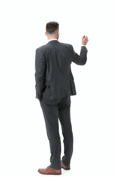 rear view.businessman writing on a virtual chalkboard.isolated on white background