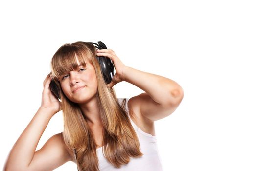 Lovely girl listening a music in headphones, white background