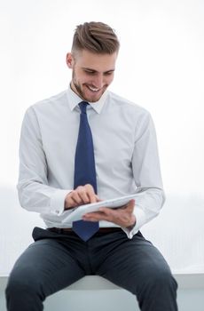 close up.smiling businessman looking at the digital tablet screen.people and technology