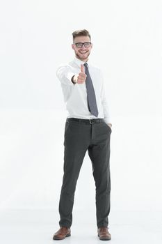 in full growth.smiling businessman showing thumb up.isolated on white background