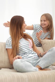 guess who. mom plays with her daughter . the concept of family happiness