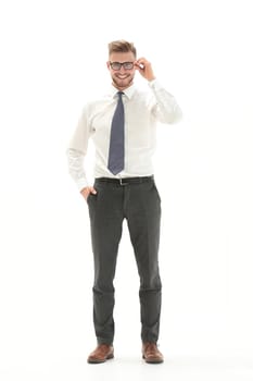 in full growth.young businessman adjusting his glasses.isolated on white background