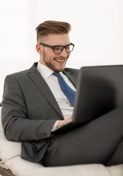 close up.businessman using laptop sitting in chair. photo with text space
