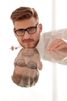 close up.confident businessman at the glass table.business concept