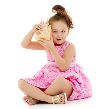 A little girl with a sea shell. The concept of a family vacation at sea, ecology. Isolated on white background.