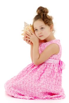 A little girl with a sea shell. The concept of a family vacation at sea, ecology. Isolated on white background.