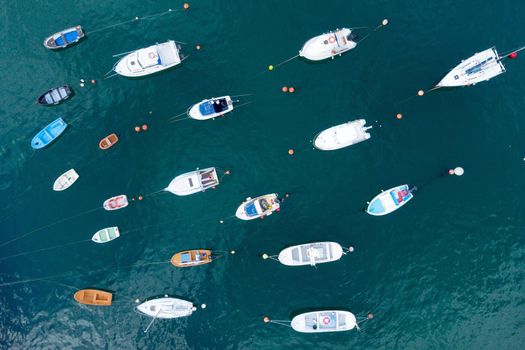 Aerial top down view of yachts and boats moored at a marina. High quality photo.