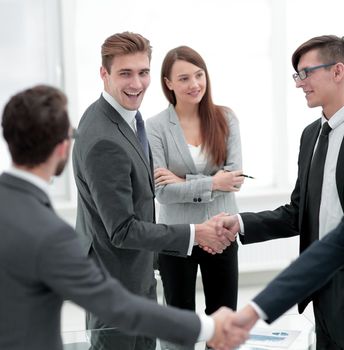 handshake of business people standing in office.