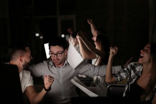 triumphant employees at the Desk.the concept of teamwork