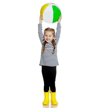A nice little girl is playing with a big inflatable ball. The concept of a happy childhood, family recreation in nature, fitness and exercise. Isolated on white background.