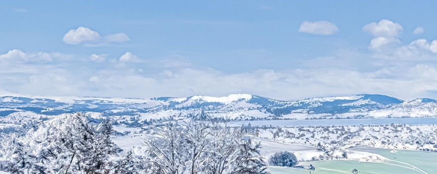 Winter wonderland and magical Christmas landscape. Snowy mountains and forest covered with snow as holiday background.