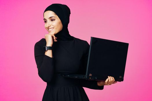 cheerful muslim woman with laptop education student internet technology. High quality photo