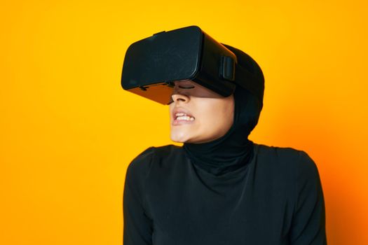 pretty woman in black hijab VR glasses emotions isolated background. High quality photo