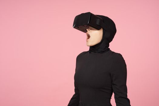 woman in black hijab glasses virtual reality technology movie watching. High quality photo