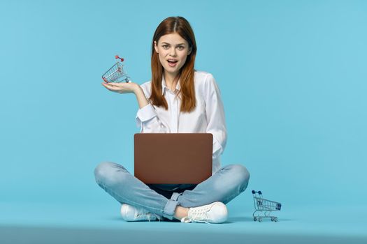 woman with laptop learning internet online education blue background. High quality photo