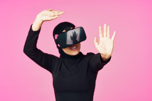 muslim woman wearing virtual reality glasses entertainment technology device. High quality photo