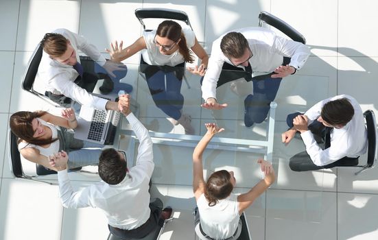 top view.company employees giving each other high five.success concept