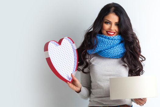 Woman in winter scarf open heart shaped box, Valentines day love concept