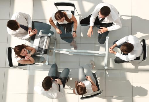 top view.business team sitting at the office table.the concept of teamwork
