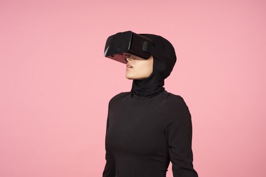 woman in black hijab glasses virtual reality technology movie watching. High quality photo